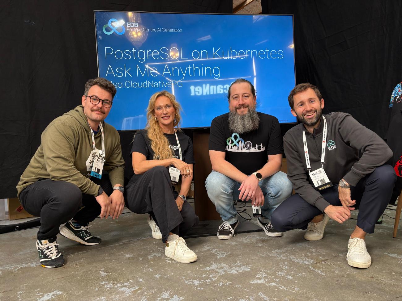EDB team members group photo in front of a screen that reads "PostgreSQL on Kubernetes AMA"