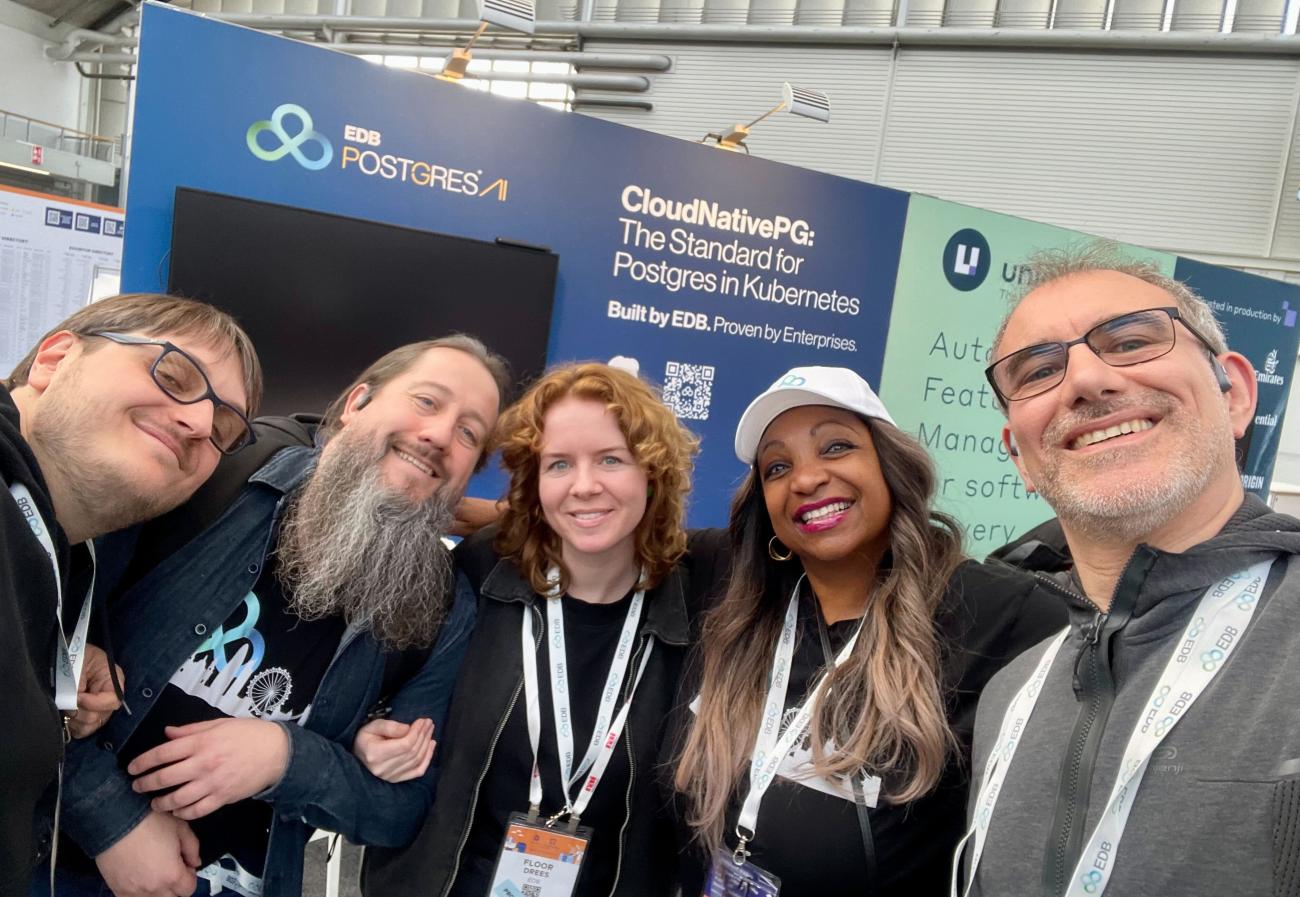 Gabriele Quaresima, Jonathan Gonzalez, Floor Drees, Zulayka Martis, and Marco Nenciarini posing for a team picture in front of the EDB booth