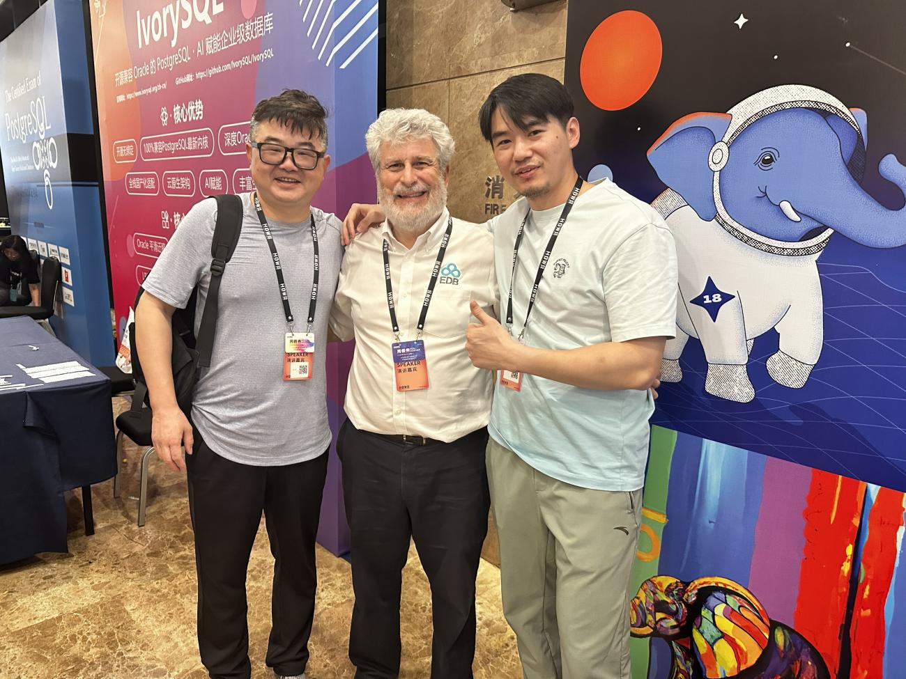 Tao LI, Bruce Momjian, and Yanni Hu posing for a group photo