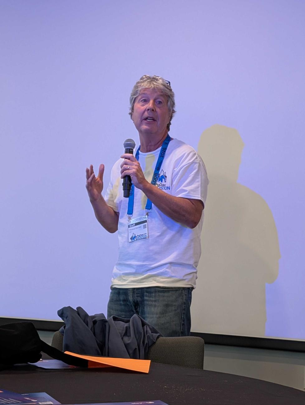 Tom Kincaid holding a microphone
